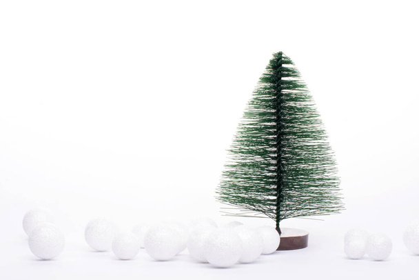 One tiny Christmas trees isolated on white. - Zdjęcie, obraz
