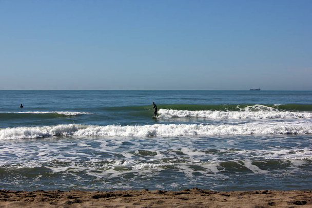 Surfing in corona times at Forte dei Marmi, Tuscany, Italy - Photo, Image