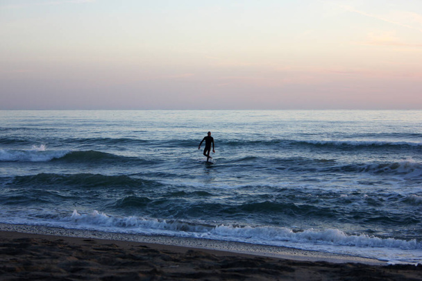 Surfing in corona times at Forte dei Marmi, Tuscany, Italy - Photo, Image