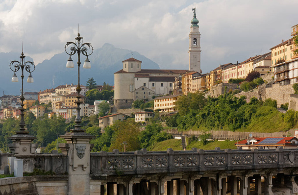 Skyline of Belluno, Italy, with the Vittoria bridge over the river Piave in the foreground - Photo, Image