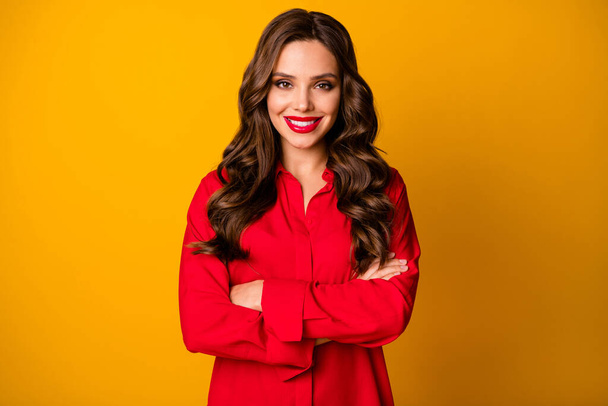Photo of pretty stunning curly business lady bright pomade bossy person friendly smiling white teeth arms crossed wear office red shirt isolated yellow vivid color background - Foto, Bild