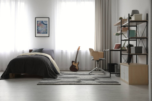 Modern teenager's room interior with workplace and bed - Foto, immagini