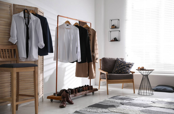 Dressing room interior with clothing rack and armchair - Fotoğraf, Görsel