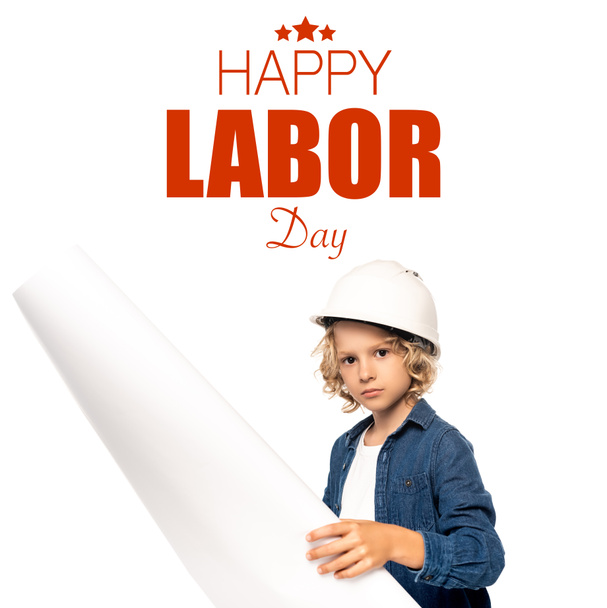 boy in safety helmet and costume of architect holding blueprint happy labor day lettering on white - Photo, Image