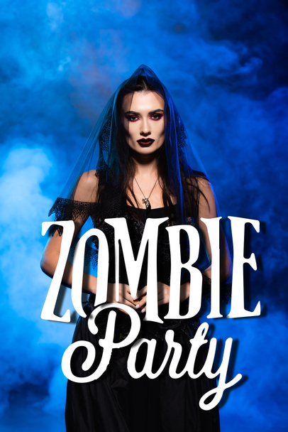 bride in black dress and veil near zombie party lettering on blue with smoke - Fotoğraf, Görsel