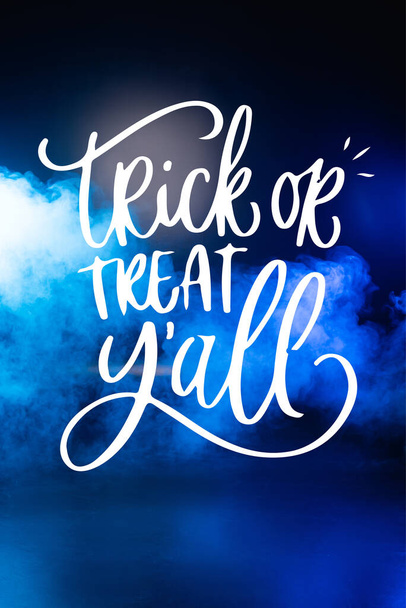 trick or treat yall lettering on dark blue background with smoke - Фото, изображение