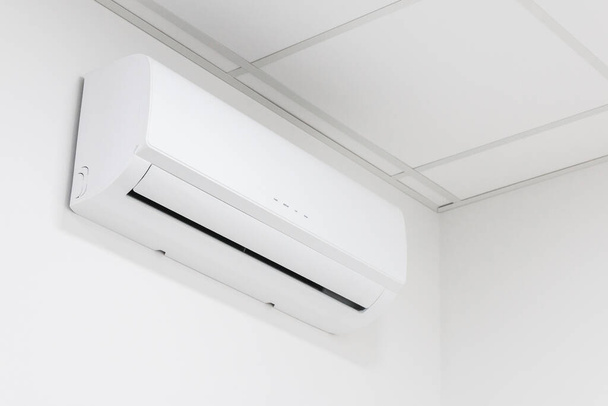 white heating and cooling air conditioner on white wall in office or home - Photo, Image
