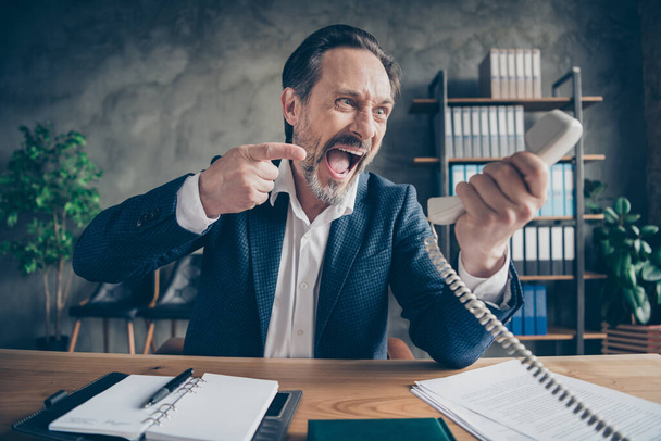 Close-up portrait of his he desperate furious fury evil jobless guy employer talking yelling on phone fight failure bad job at modern loft industrial style interior workplace workstation - Foto, Bild
