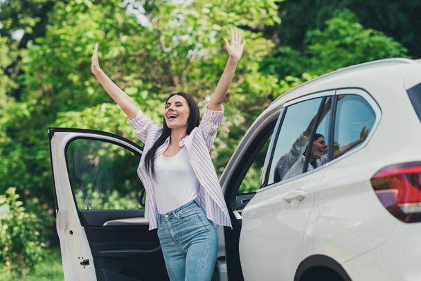 Photo of positive cheerful girl drive ride car park forest trees stop raise arms enjoy summer fresh air wind blow city town outdoors escape concept - Foto, Imagem