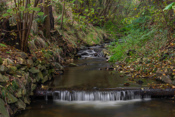 Krasetinsky creek near confluence with Kremzsky creek with small waterfall in autumn morning - Photo, Image