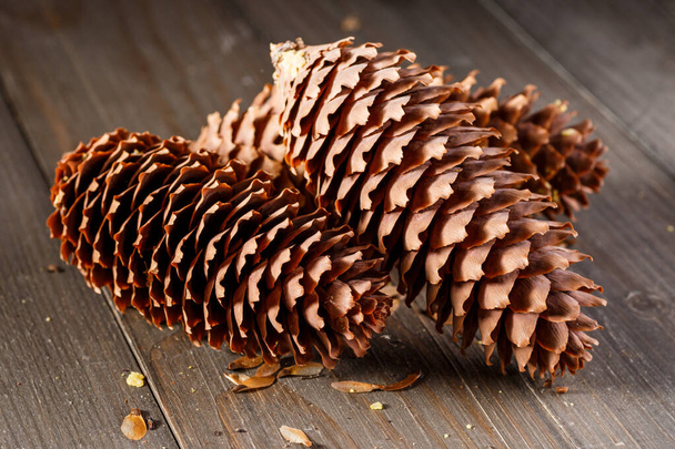 Pine cones on wooden background.Rustic natural wooden background with pine cones - Фото, изображение