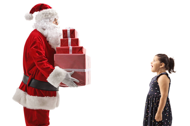 Santa Claus giving presents to an overjoyed girl isolated on white background - Fotografie, Obrázek