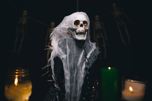 Human ghost in the guise of a skeleton in chains on a black background, halloween, spooky picture, halloween, horizontal orientation, close-up - Photo, image