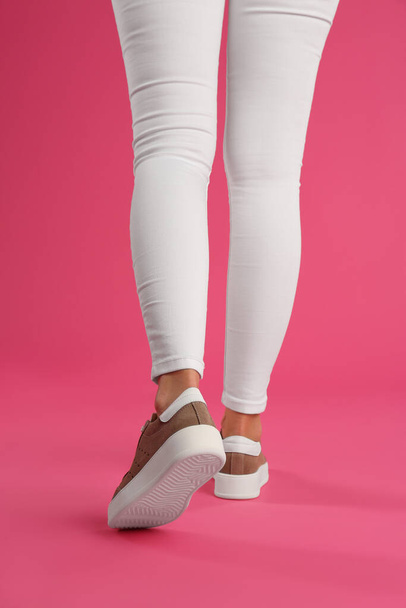 Woman wearing shoes on pink background, closeup - Foto, immagini