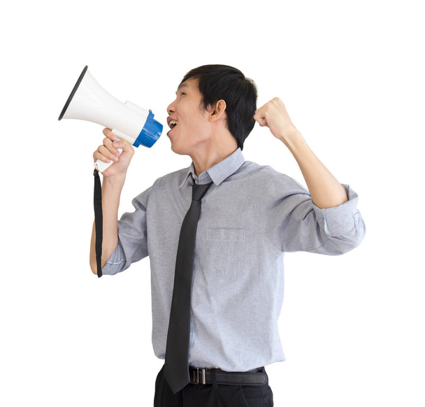 An Asian man stands holding a blue megaphone and white isolated on white background. - Foto, immagini