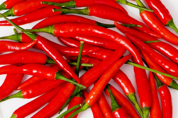 Red chili peppers arranged at the background - Photo, Image