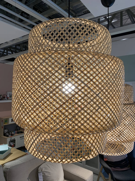 a vertical shot of a brown netted chandelier hung from the ceiling - Photo, Image