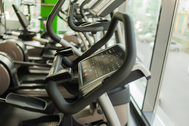 Elliptical exercise machines in the gym. Fitness, healthy lifestyle concept. - Photo, Image