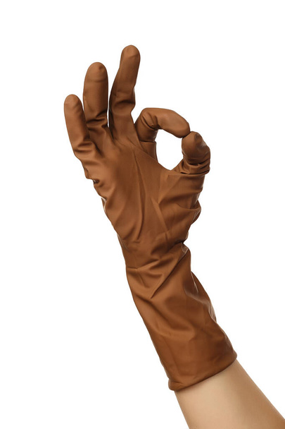 Female doctor's hand in brown surgical medical glove showing ok approval sign isolated on white background - Photo, Image