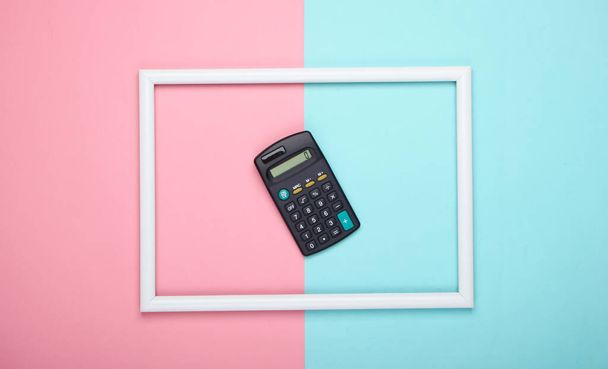 Calculator in white frame on pink blue pastel background. Top view - Zdjęcie, obraz