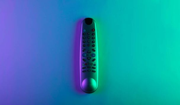 Tv remote with green magenta neon light. Вид сверху - Фото, изображение