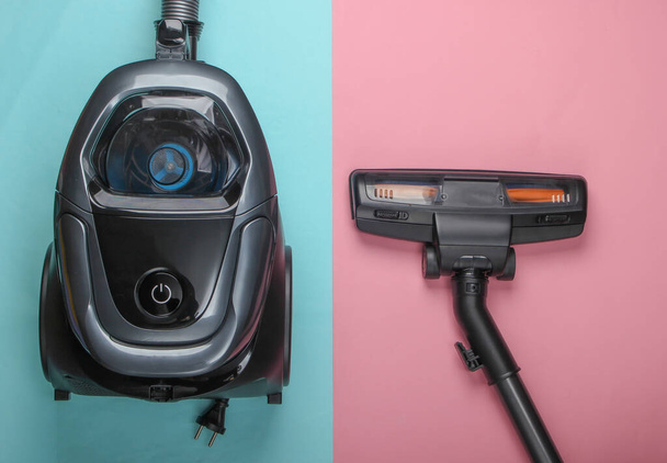 Vacuum cleaner on pink blue pastel background. Top view. Cleaning concept. - Photo, Image