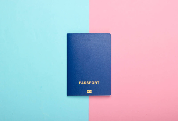 Tourism and travel concept. Emigration. Passport on pink blue background. Top view. - Photo, image