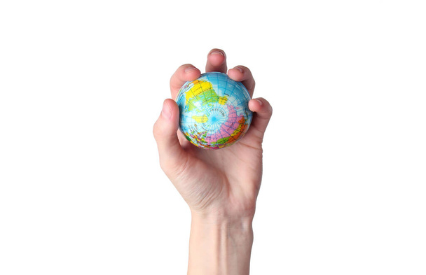 Globe in a female hand on isolated on white background. - Foto, Imagen