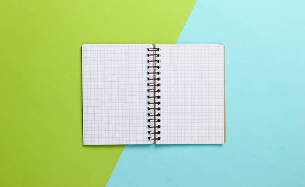 Notepad on a blue-green pastel background. Top view. Planning or education concept. - Fotografie, Obrázek