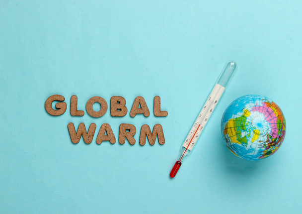 Global warming concept. Globe and thermometer on blue background. Top view - Photo, Image