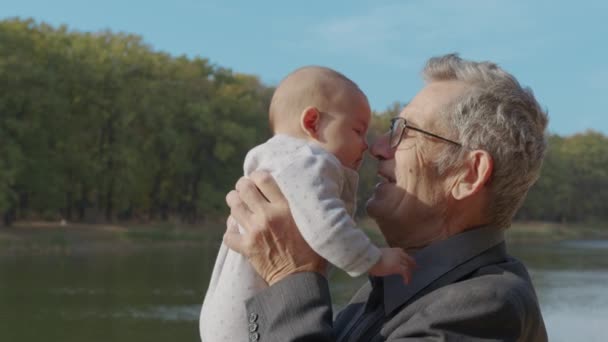 Funny Game and Laugh of Caucasian Old Man and Baby Girl in Domestic Comfort. Wrinkled Skin of Grandfather or Gray Haired Father. Gentle Embrace and Happy Smile grandParent. - Footage, Video
