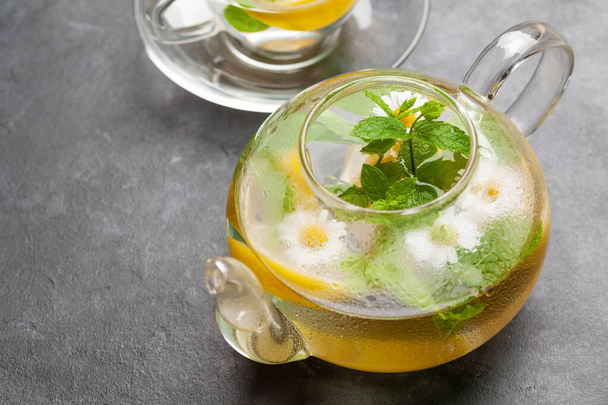 Traditional herbal tea with lemon, chamomile flowers and mint - Photo, image