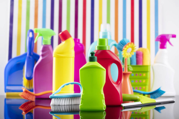 Tema de limpieza de casa y oficina. Conjunto colorido de botellas con líquidos inclinados en el fondo en forma de rayas de colores. - Foto, Imagen
