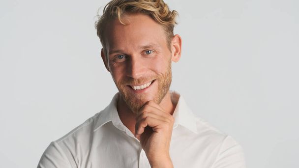 Successful smiling blond bearded man happily posing on camera over white background. Happy expression - Foto, Imagem