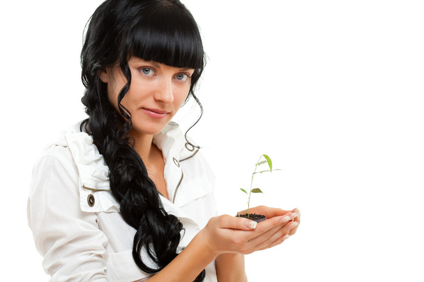 Woman holding green plant - Foto, Imagen
