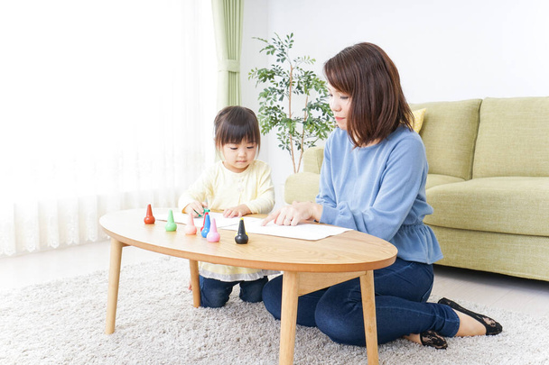 parent and child painting a picture at home - Photo, Image