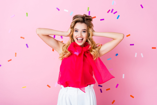 happy woman on pink background with falling confetti  - Фото, зображення