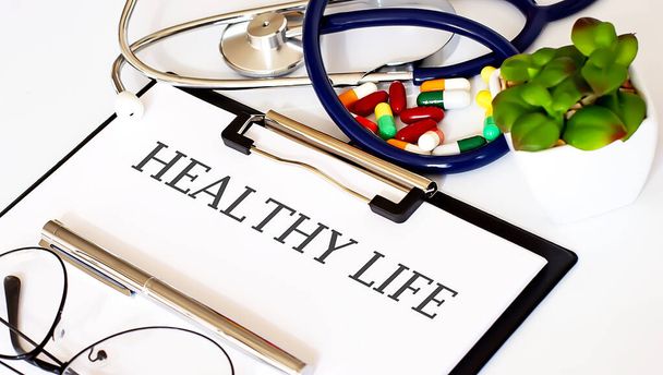 HEALTHY LIFE text with Background of Medicaments, Stethoscope - Photo, Image