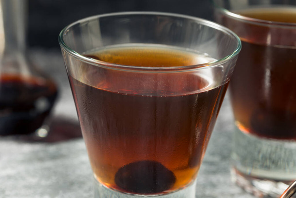 Boozy Refreshing Manhattan Cocktail with a Cherry Garnish - Photo, image