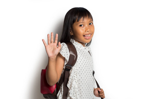 Beautiful Asian little girl hold a books with school bag is back to school  Educational concept for school - Foto, imagen
