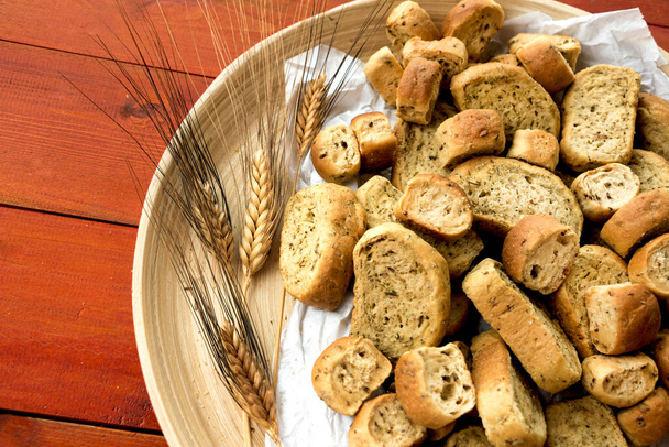 Bread rusks and croutons in wooden plate. - Photo, Image