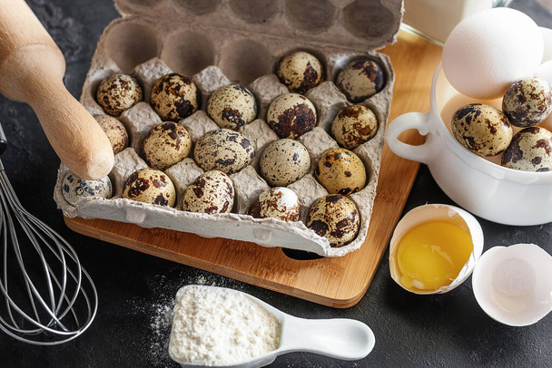 quail and chicken eggs close-up, flour, rolling pin, baking dish - Foto, Imagem