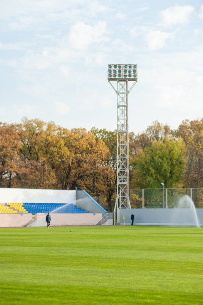 Floodlights over the field with clouds in the background. - Zdjęcie, obraz