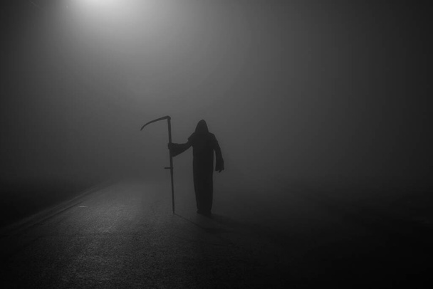 Death grim Reaper skeleton wearing a black robe and wielding a scythe, Memento Mori, Coronavirus, Epidemic and Pandemic Tim - Photo, Image