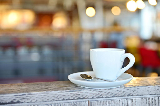 Coffee cup in Prague cafe 2020. Coffee cup in Prague cafe 2020. White mug with coffee on a white saucer. Hot coffee in a mug. Romantic background with cafe. - Foto, afbeelding