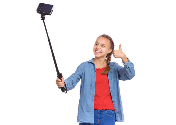 Teen girl with selfie stick - Foto, afbeelding