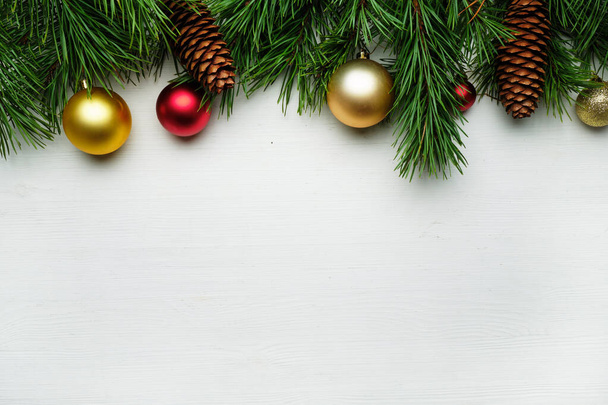 Christmas tree branches and christmas toys on a wooden background copy space. - Photo, Image
