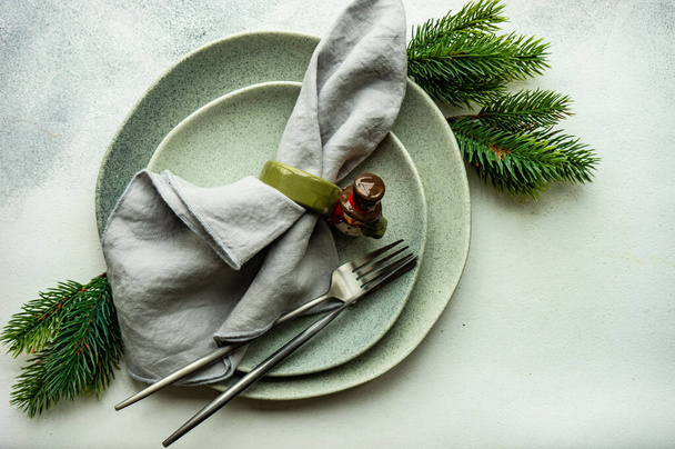 Festive place setting for celebration the Christmas eve on concrete table - 写真・画像