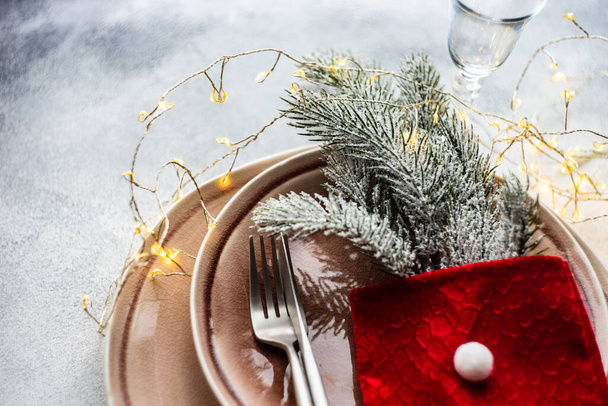 Festive place setting for celebration the Christmas eve on concrete table - 写真・画像