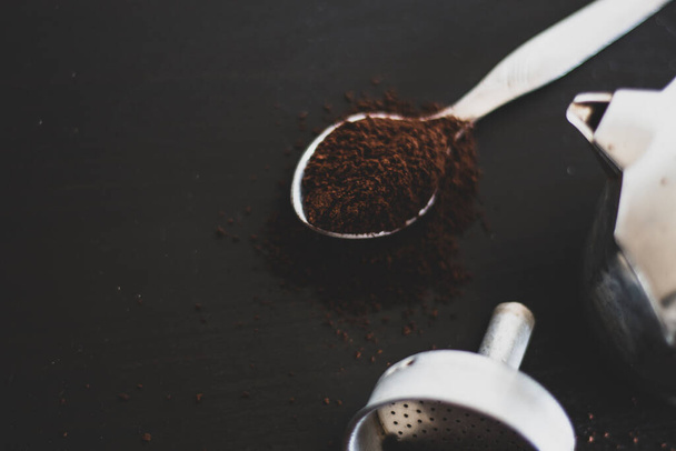 Ingredients for making moka coffee. Moka pot with coffee on dark background. Coffee making concept. - 写真・画像